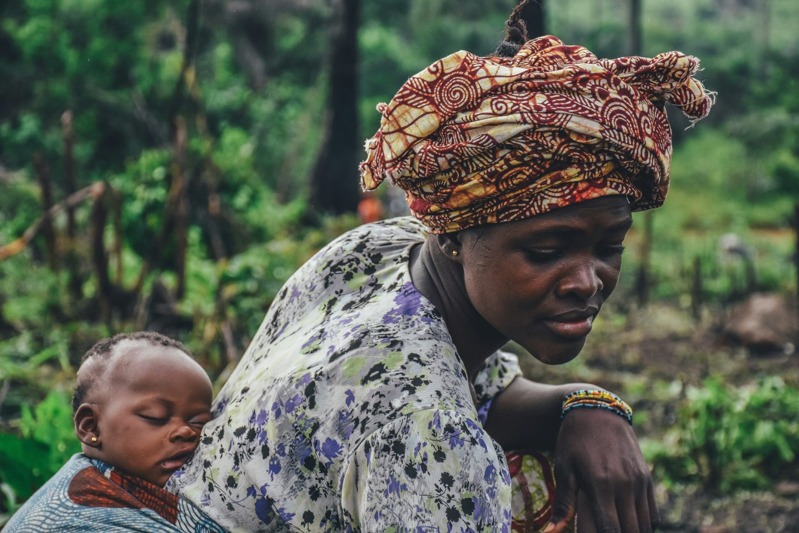 woman carrying baby on back